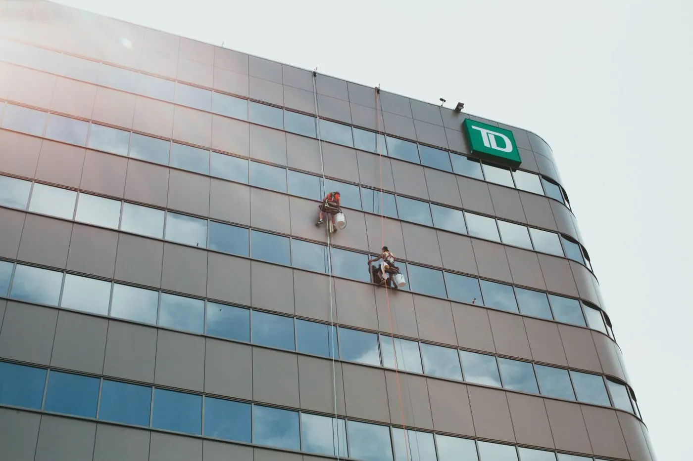 Workers cleaning building glass panels